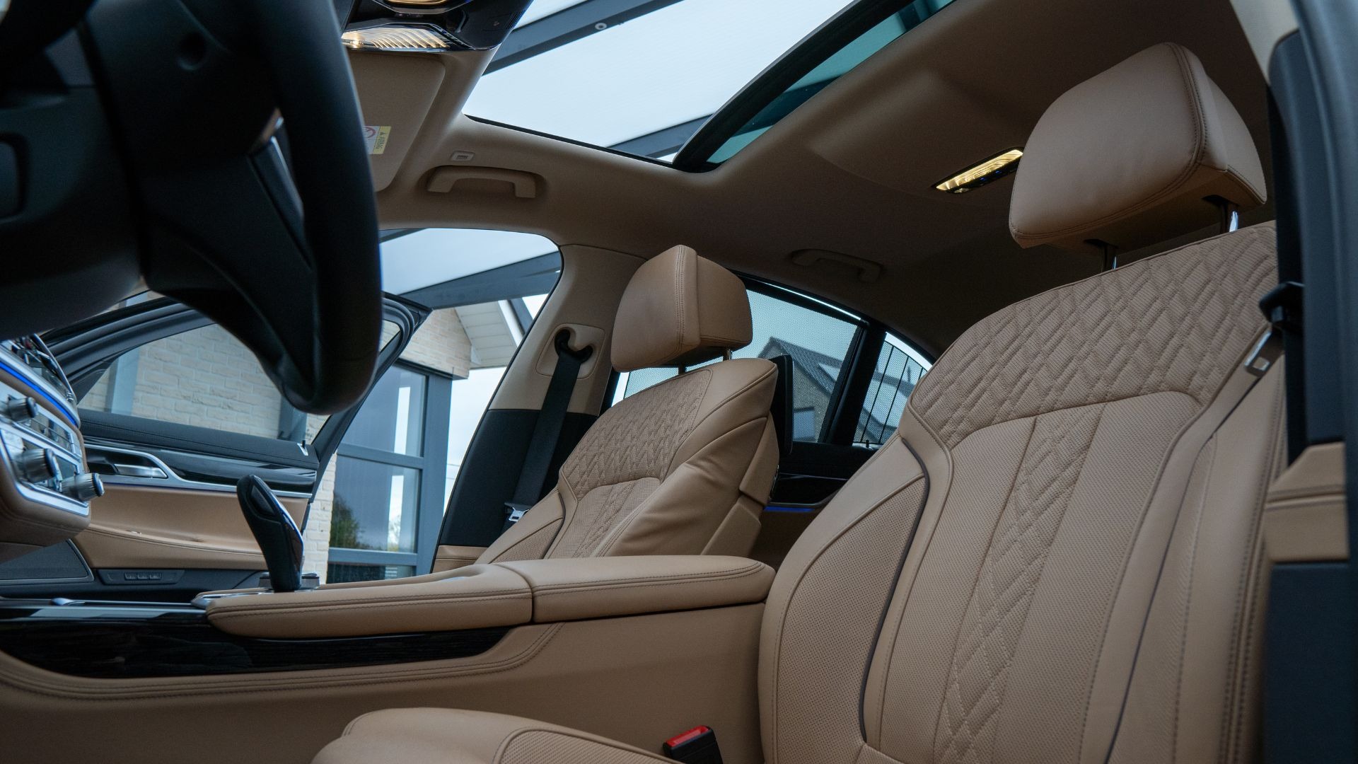First-class luxury limousine cabin with warm ambient lighting and panoramic starry roof